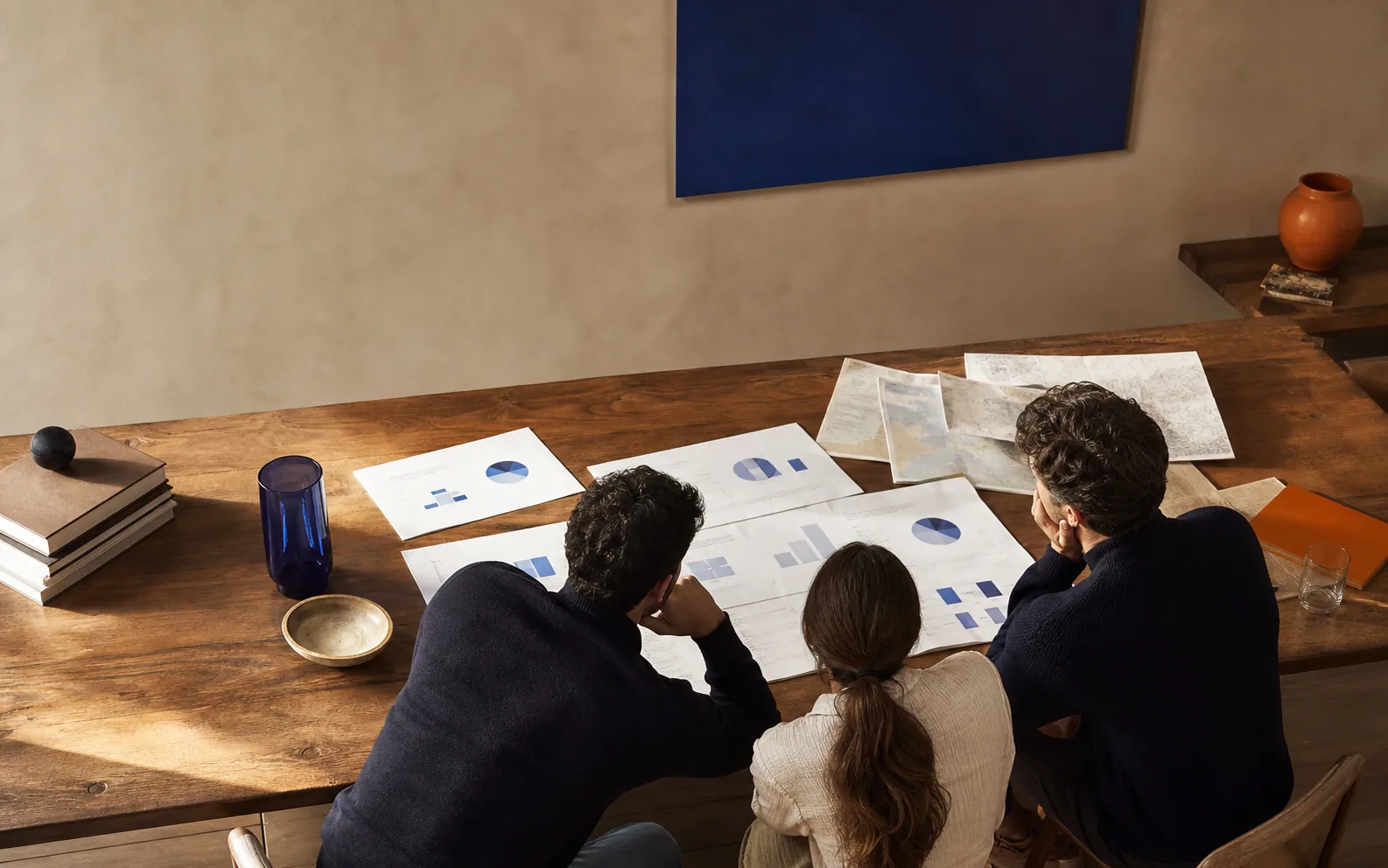 A team reviewing useful work around a studio table