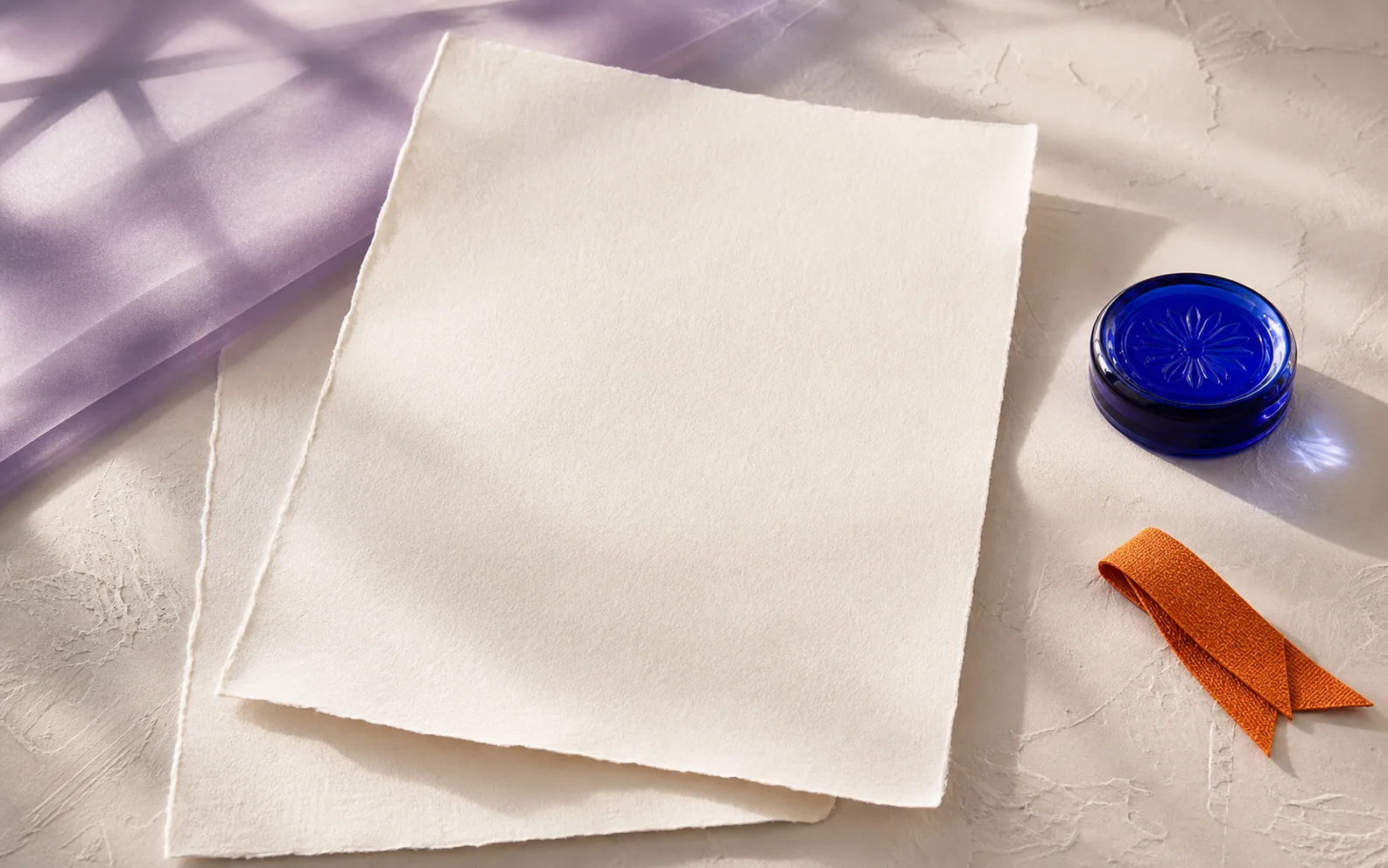 Abstract documents and a glass seal on a calm studio surface